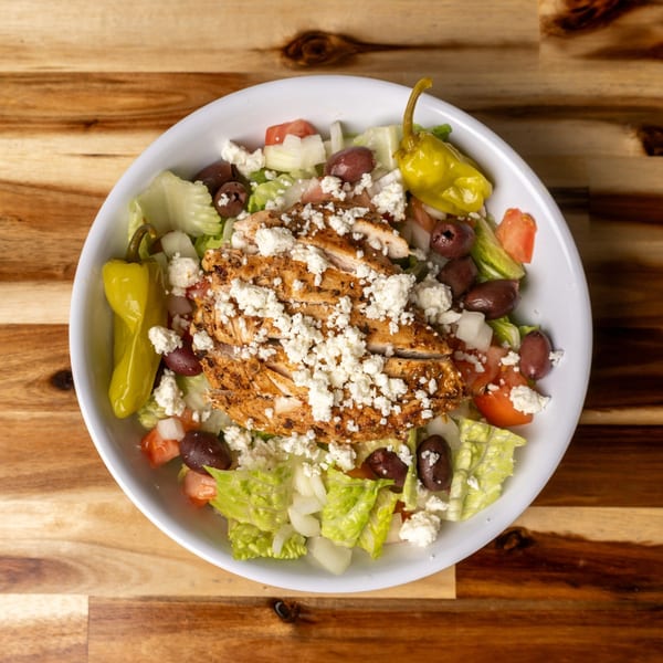 Jaxx Wing Co. grilled chicken salad with lettuce, tomatoes, olives, feta, and pepperoncini.